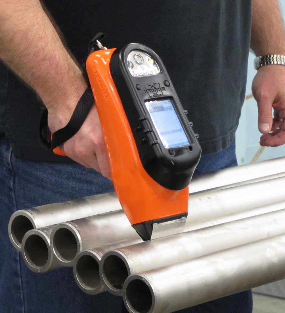 a man checking quality of pipes with magnetic particle inspection (MPI) machines